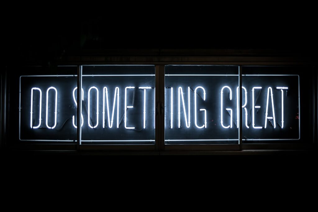The image-6 product features a white neon sign on a dark background that displays the phrase “DO SOMETHING GREAT,” providing even illumination for an inspiring and motivational effect.