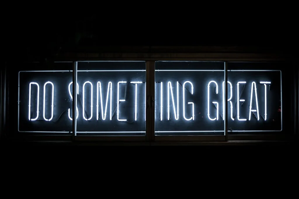 The image-6 product features a white neon sign on a dark background that displays the phrase “DO SOMETHING GREAT,” providing even illumination for an inspiring and motivational effect.