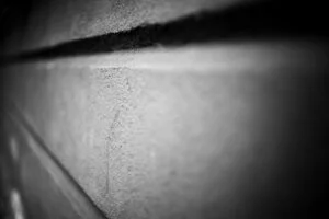 Close-up, black-and-white photo titled "image-2" shows a textured concrete wall with horizontal lines, captured at an angle. The foreground is sharp while the background softly fades out of focus.