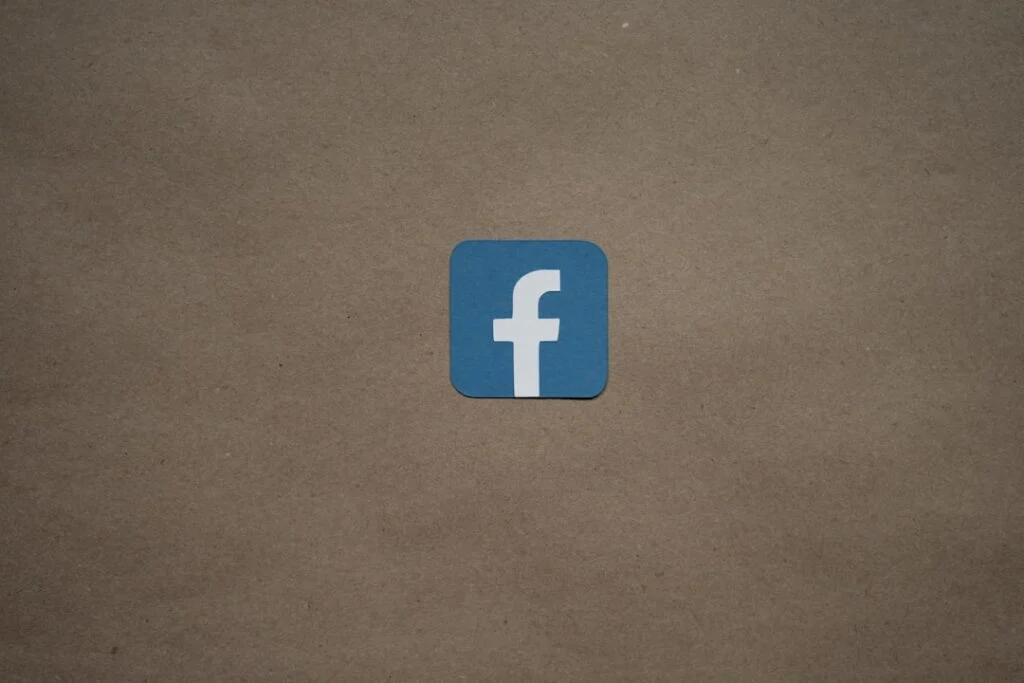 Image-4 displays a blue square featuring a white lowercase "f," symbolizing the Facebook logo, centered on a plain brown background.