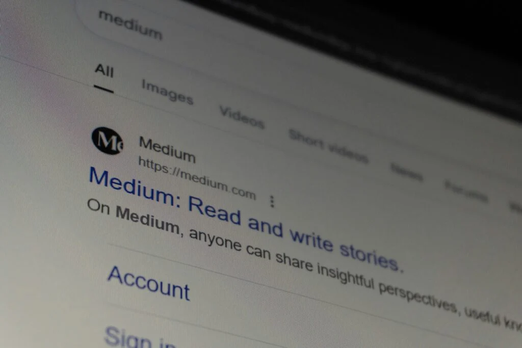 A computer screen displays a Google search result for 050920261788571011.jpeg, showing the link and a brief description about reading and writing stories on the site.